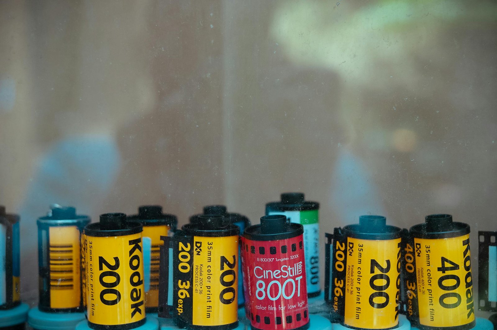 Close-up view of assorted film cartridges including Kodak and CineStill brands.